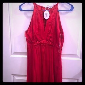 Red, satin dress with detail at natural waist.